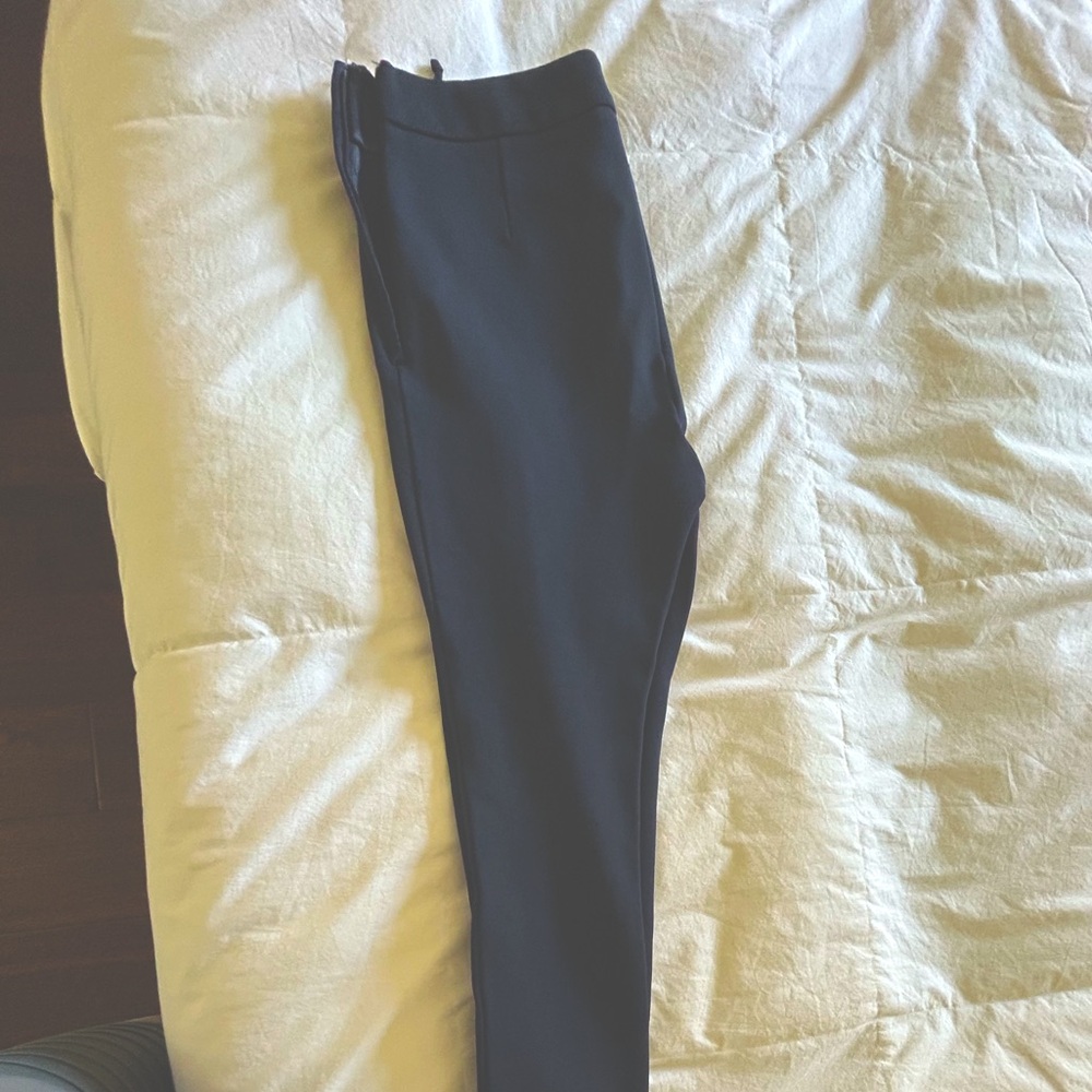 Valentino skinny stretch pants with zipperr accents at the bottom.